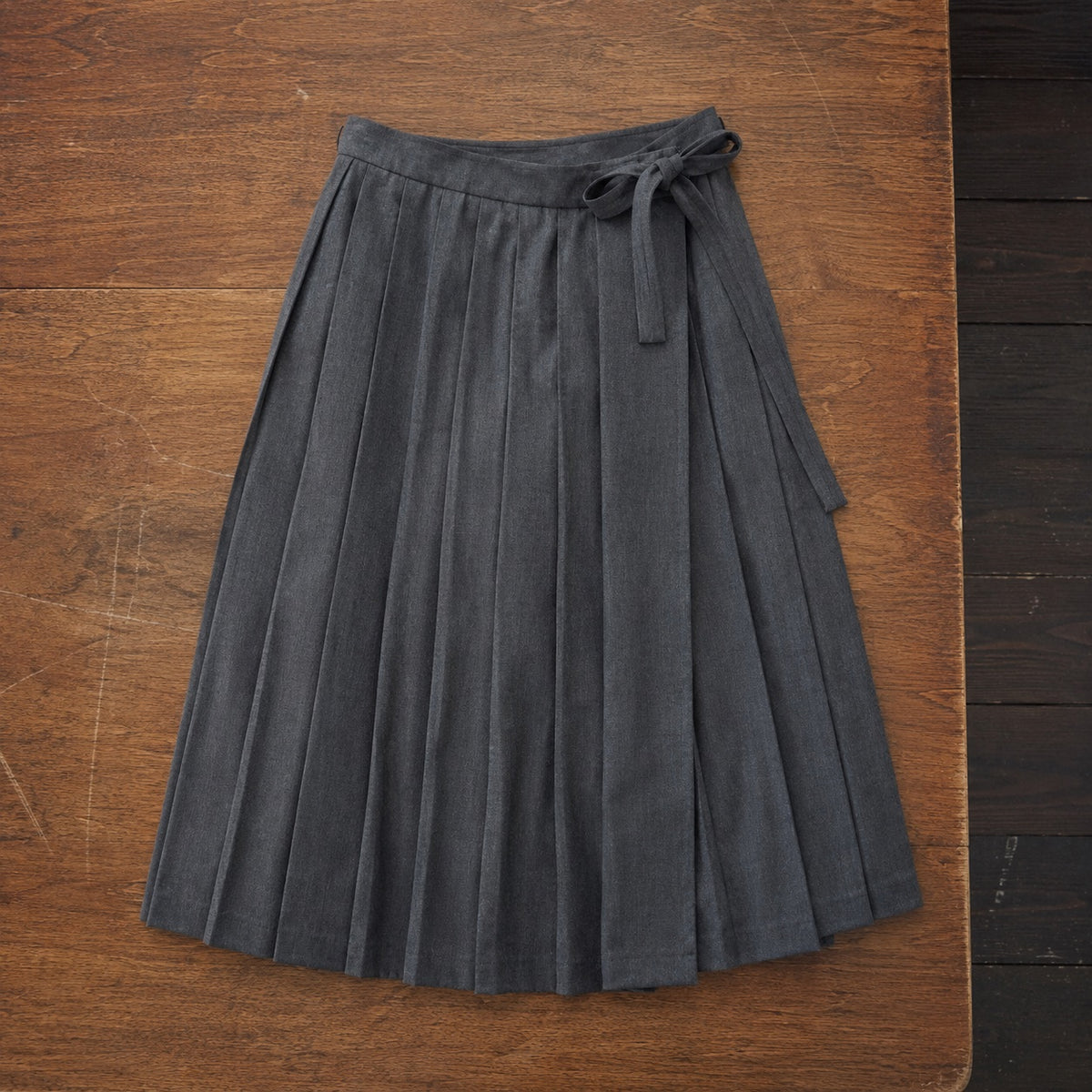 Pimlico box-pleated wrap skirt — Tailored Skirts by CROWN TAILORING. flat lay, front.